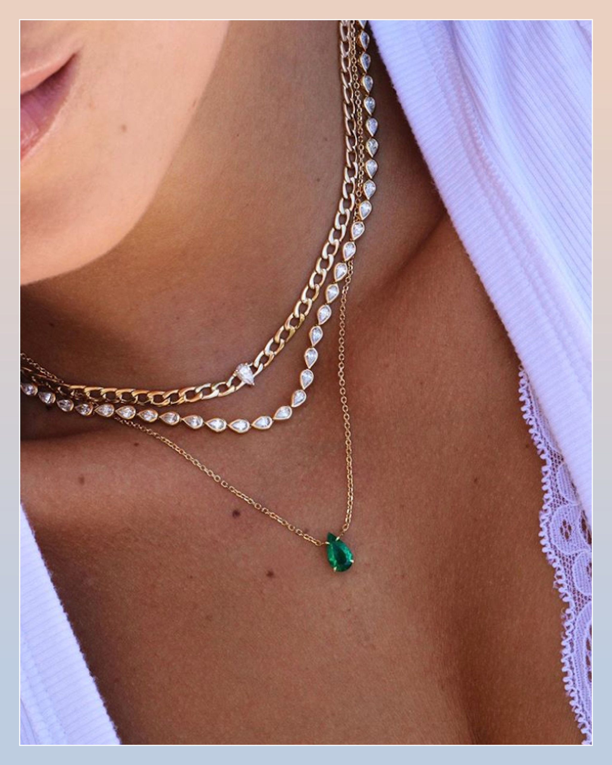Pear shaped diamond riviere necklace paired with a gold choker necklace and an emerald necklace on a gold chain by Anita Ko