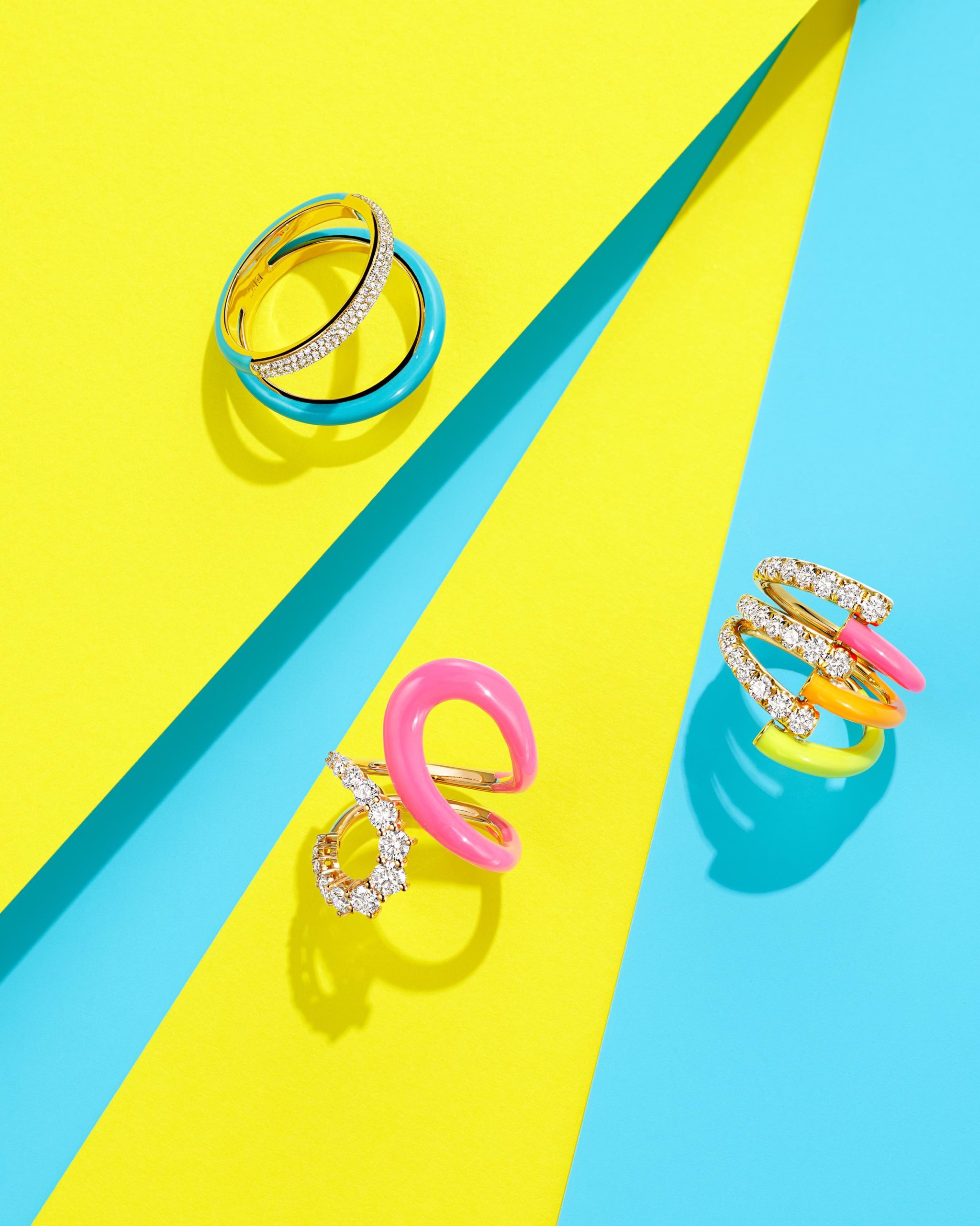 Bright blue enamel and diamond two band ring by EF Collection,  pink, orange & yellow enamel and diamond vine ring by Melissa Kaye, and abstract bright pink enamel & diamond band ring by Melissa Kaye