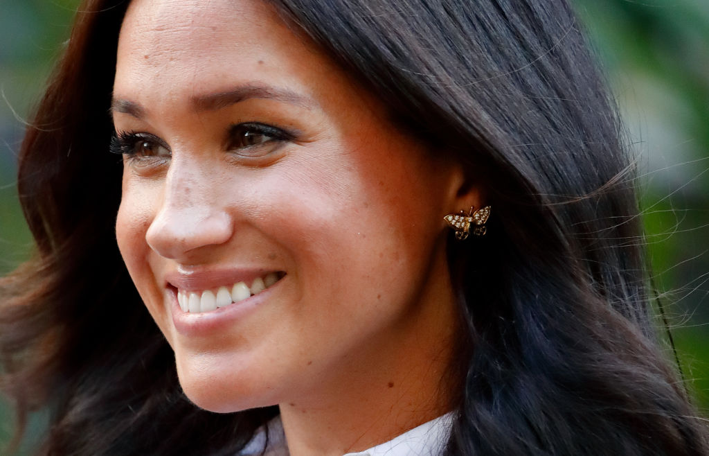 Meghan Markle wearing gold butterfly earrings. 