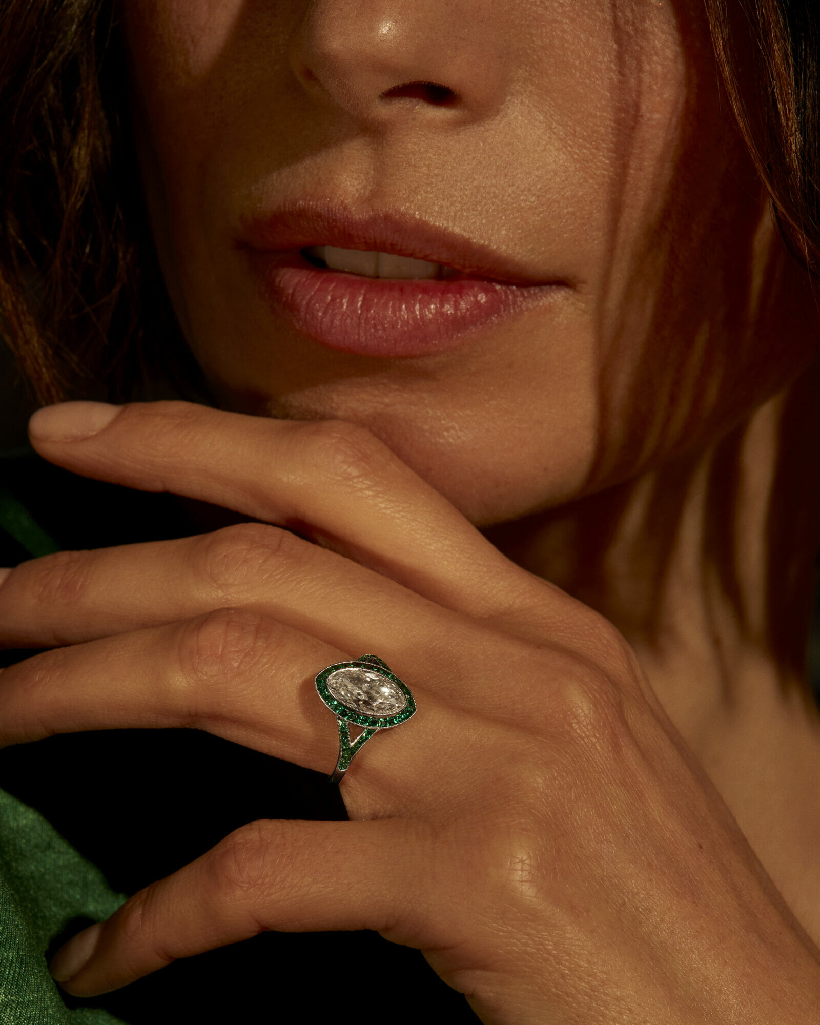 Marquise cut ring, woman wearing kwiat diamond ring, green closeup