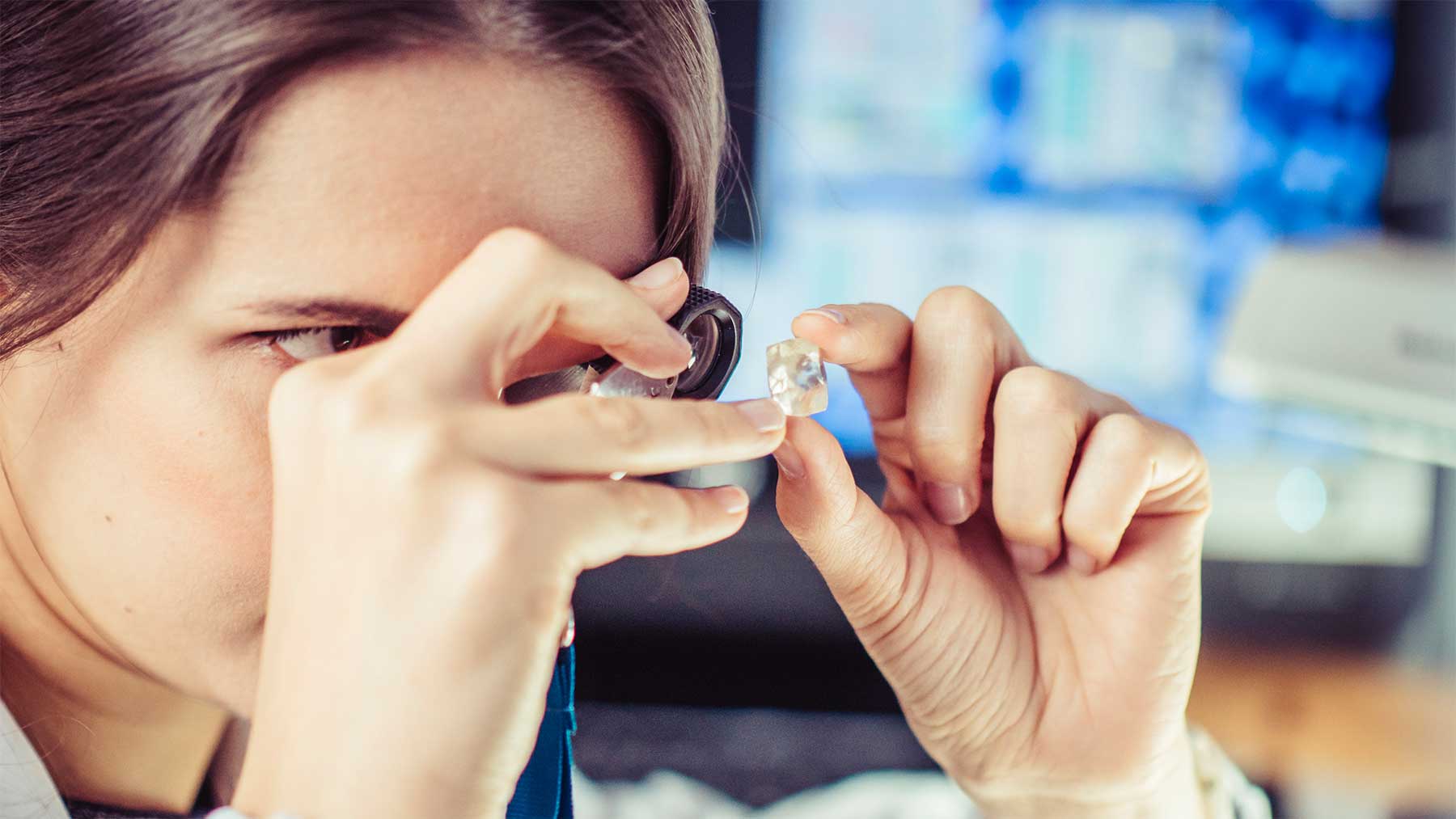 A woman checking diamond quality 